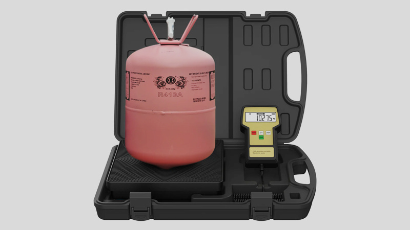 A close-up shot of a digital refrigerant scale with a recovery tank sitting on it. The clear digital display shows a weight of 65.8 lbs, just under the calculated safe limit.