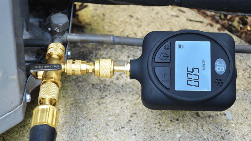 Micron gauge displaying deep vacuum level on an AC system