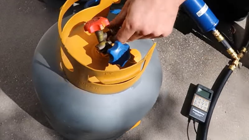 Technician actively working on speeding up refrigerant recovery