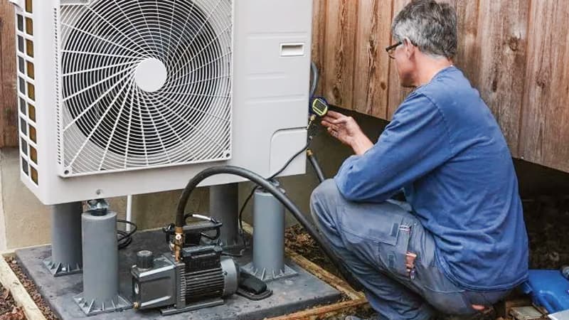Technician with Vacuum Pump Setup