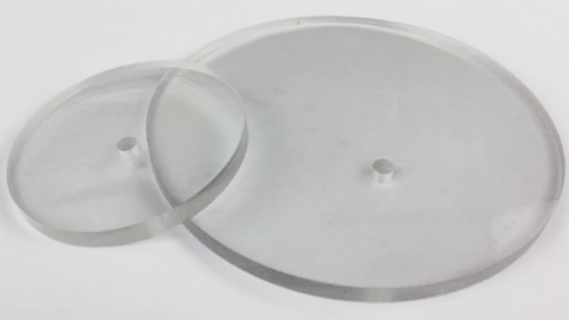 A side-by-side view of a chamber with a clear acrylic lid and another with a heavy, tempered glass lid