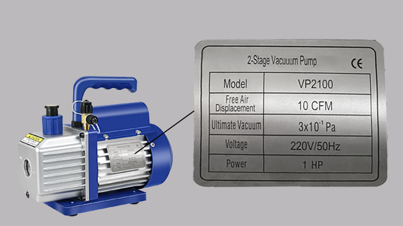 A close-up shot of a vacuum pump's metal nameplate, with the 