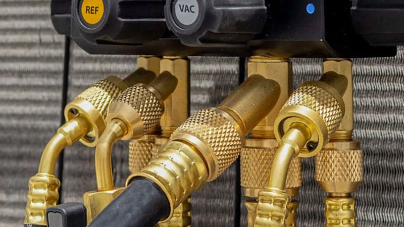 A clear side-by-side photograph of a standard yellow charging hose and a thick, black, purpose-built vacuum hose, highlighting the difference in their construction and diameter