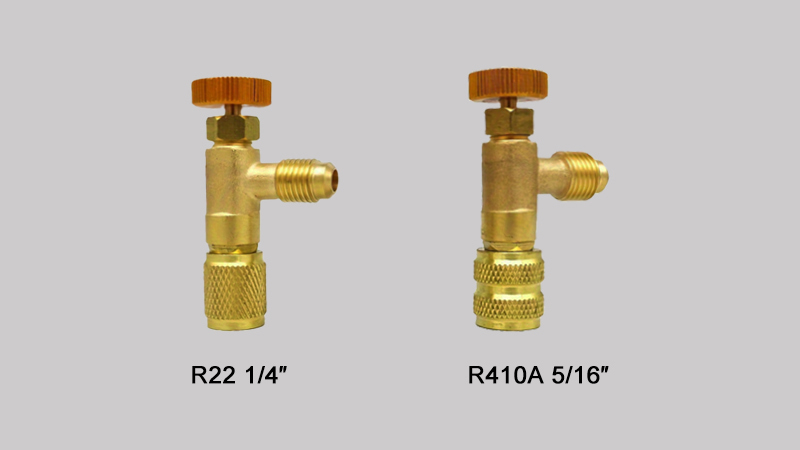 A technician's hands holding two different hose ends up for comparison: one is a standard 1/4