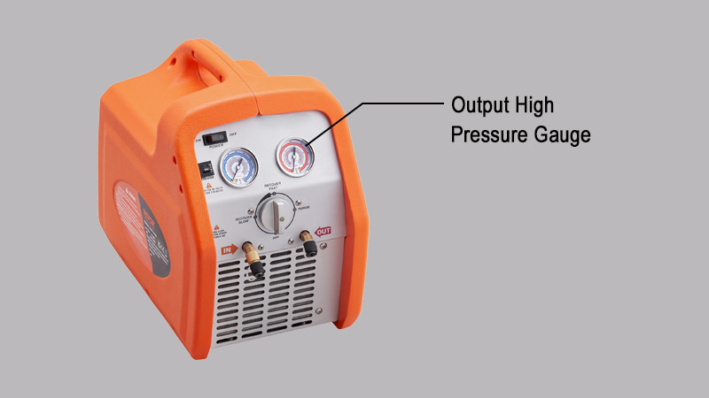 A close-up on the red, high-pressure gauge of a recovery machine, with the needle pushed far into the warning zone, and a technician's finger pointing to the small, red reset button