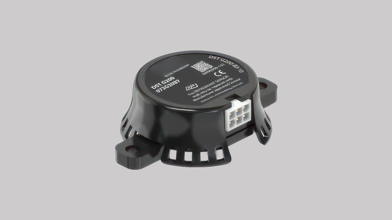 A small, discreet, permanently installed A2L refrigerant sensor mounted on the wall near the indoor evaporator coil of a furnace