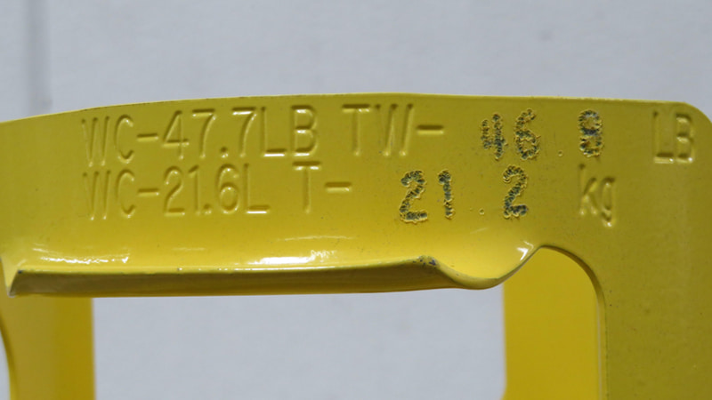 A technician pointing to the stamped 