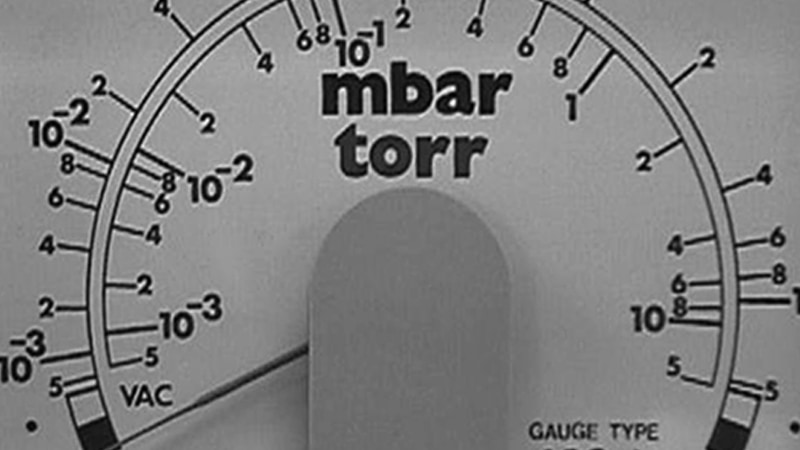 A collage of four different pressure gauge faces, each one clearly showing a different primary unit: Torr, mbar, Pa, and Microns