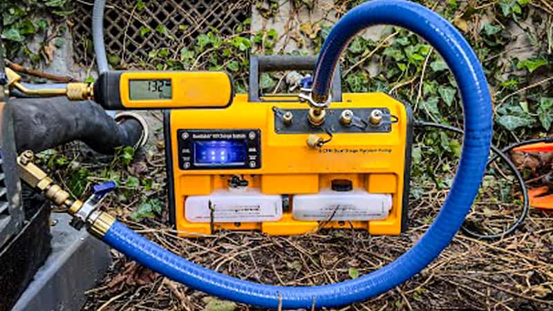 A clear visual of the problem: a large-diameter vacuum pump inlet port connected to a very thin, small-diameter yellow HVAC hose
